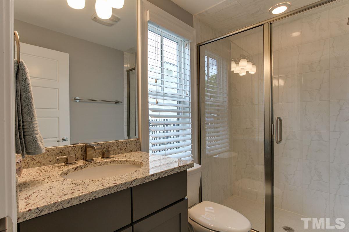 2315 Bedford Avenue Raleigh, NC 27607 - Photo 14 of 25 a bathroom with a granite countertop sink toilet and shower
