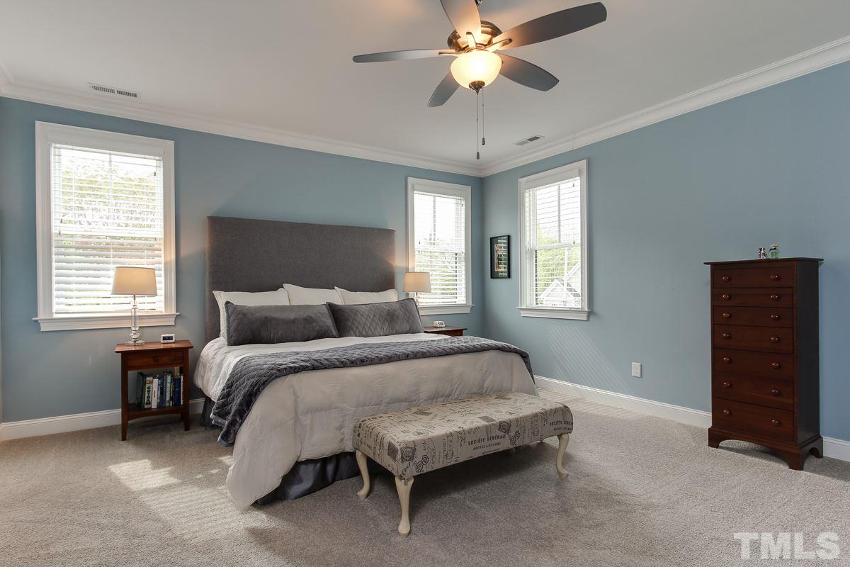 2315 Bedford Avenue Raleigh, NC 27607 - Photo 15 of 25 a spacious bedroom with a bed and a chandelier