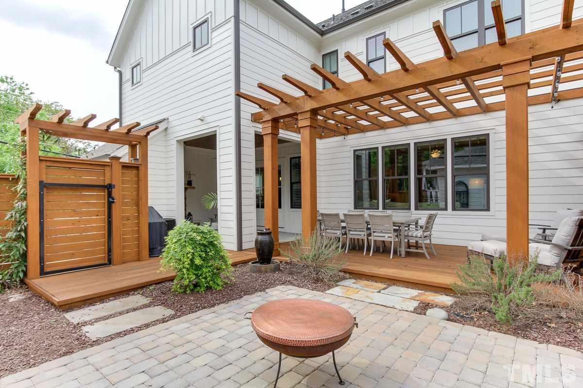 2315 Bedford Avenue Raleigh, NC 27607 - Photo 24 of 25 a view of a dinning tables and chairs in backyard of the house