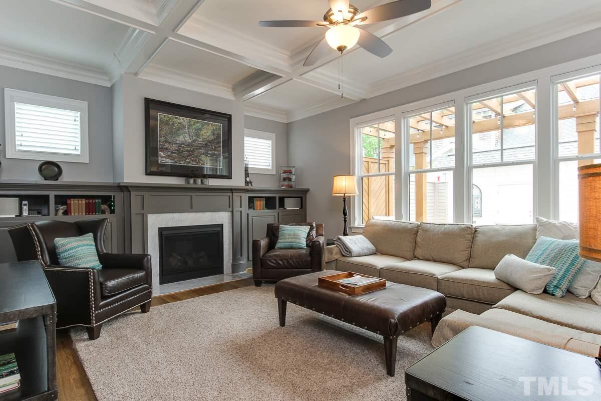 2315 Bedford Avenue Raleigh, NC 27607 - Photo 6 of 25 a living room with furniture a flat screen tv and a fireplace