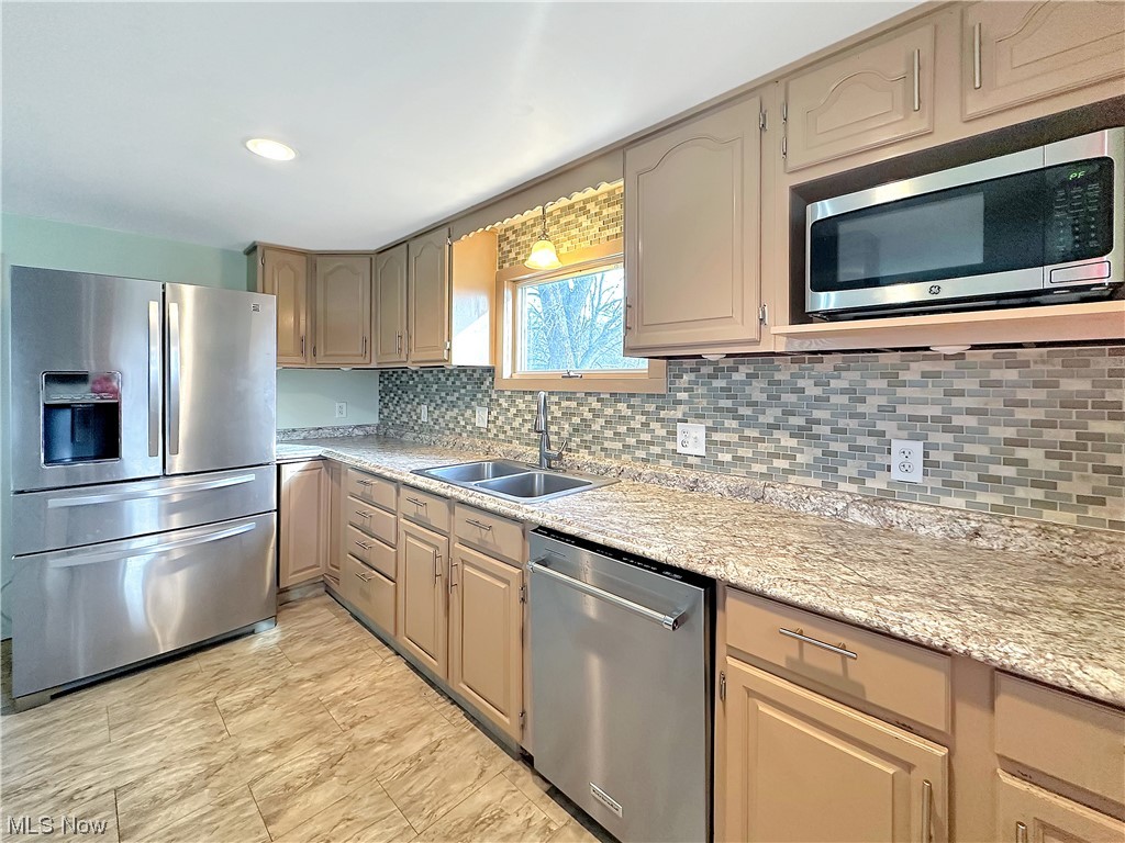 2692 Race Track Road New Cumberland, WV 26047 - Photo 10 of 25 Kitchen featuring light brown cabinetry, stainless steel appliances, light tile floors, sink, and tasteful backsplash