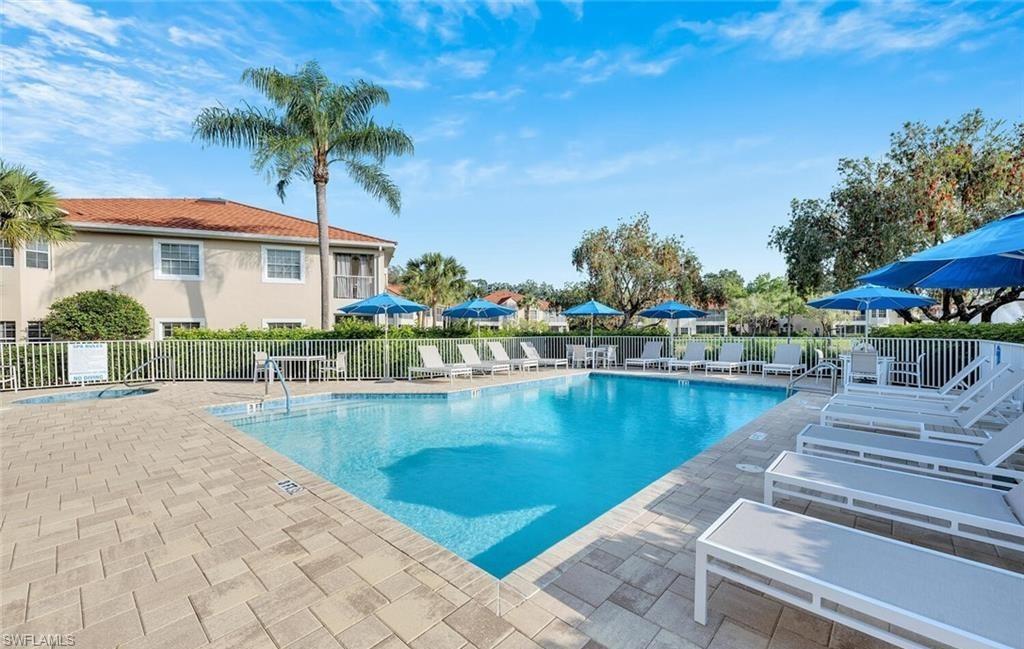 6135 Reserve Circle, Unit 1801 Naples, FL 34119 - Photo 20 of 23 Community pool featuring a patio