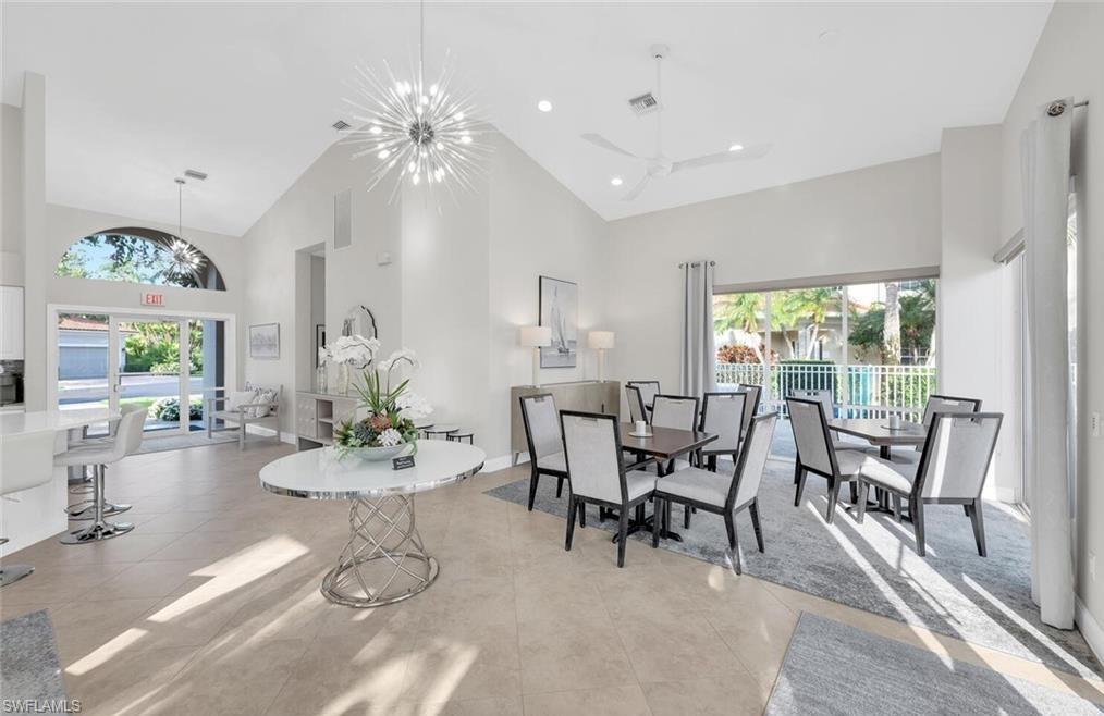 6135 Reserve Circle, Unit 1801 Naples, FL 34119 - Photo 23 of 23 Dining area with high vaulted ceiling, a chandelier, healthy amount of natural light, recessed lighting, and ceiling fan