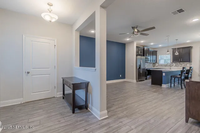 a view of kitchen with cabinets and wooden floor