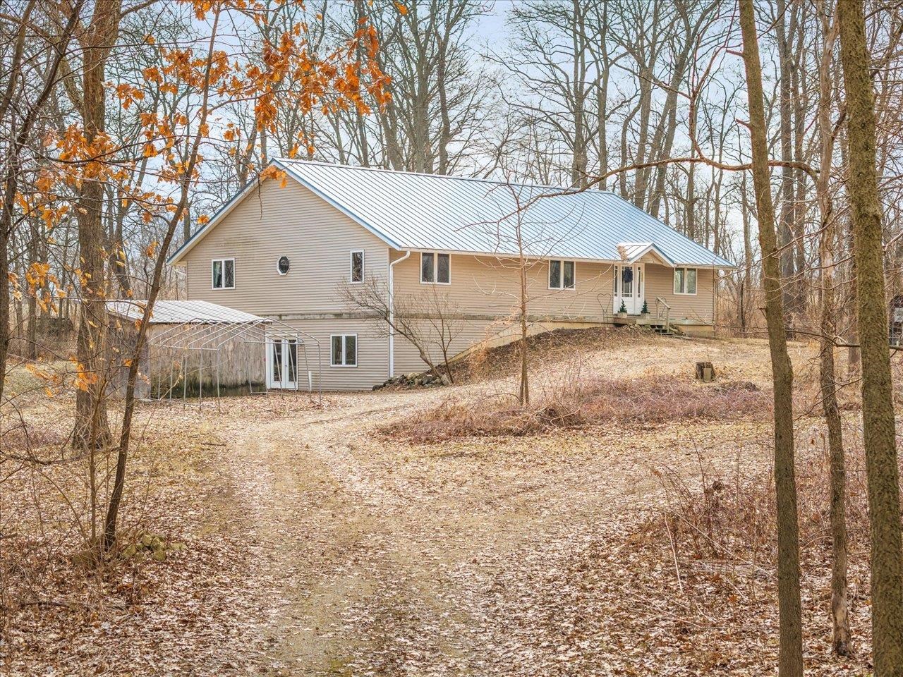 a view of a house with a yard covered in snow