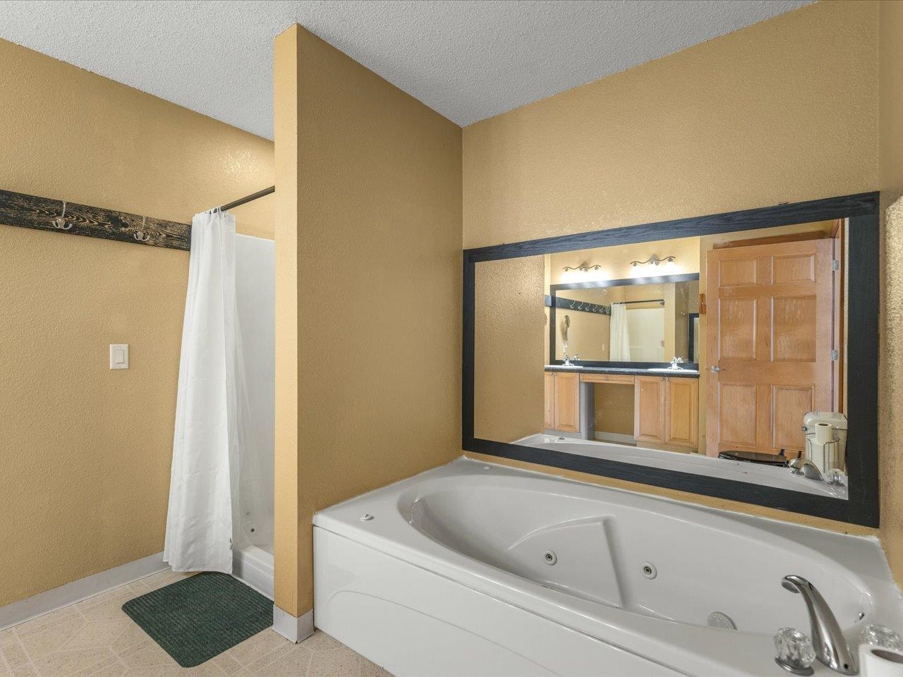 11660 Farm School Road Durand, IL 61024 - Photo 20 of 47 a bathroom with a bathtub and a shower