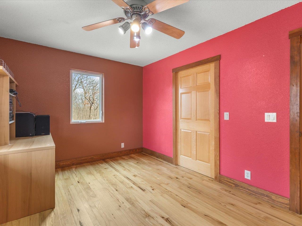 11660 Farm School Road Durand, IL 61024 - Photo 22 of 47 a view of livingroom with hardwood floor and a ceiling fan