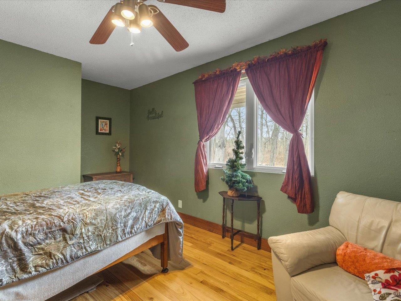 11660 Farm School Road Durand, IL 61024 - Photo 24 of 47 a bedroom with a bed and a chandelier