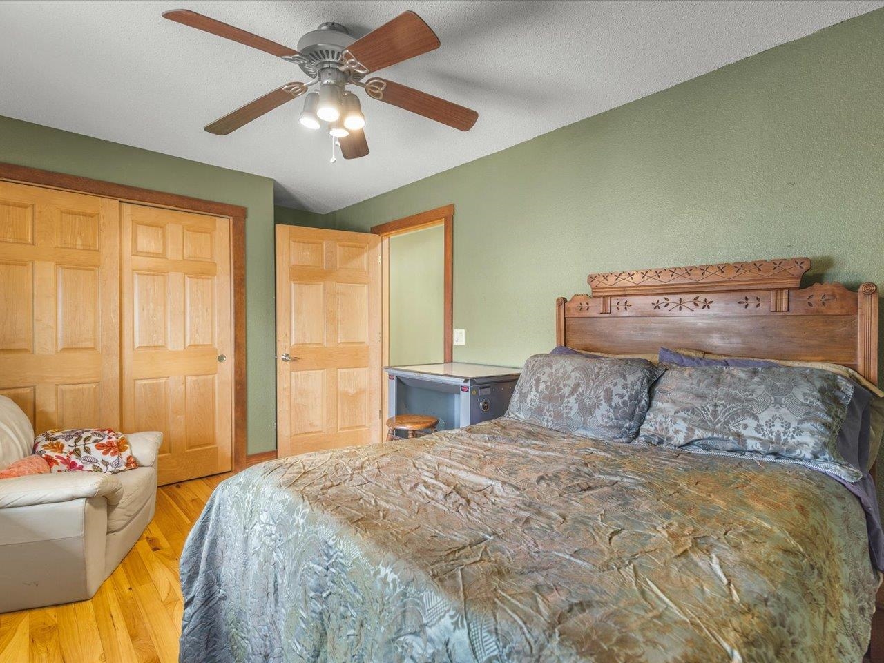 11660 Farm School Road Durand, IL 61024 - Photo 25 of 47 a bedroom with a large bed and a chandelier