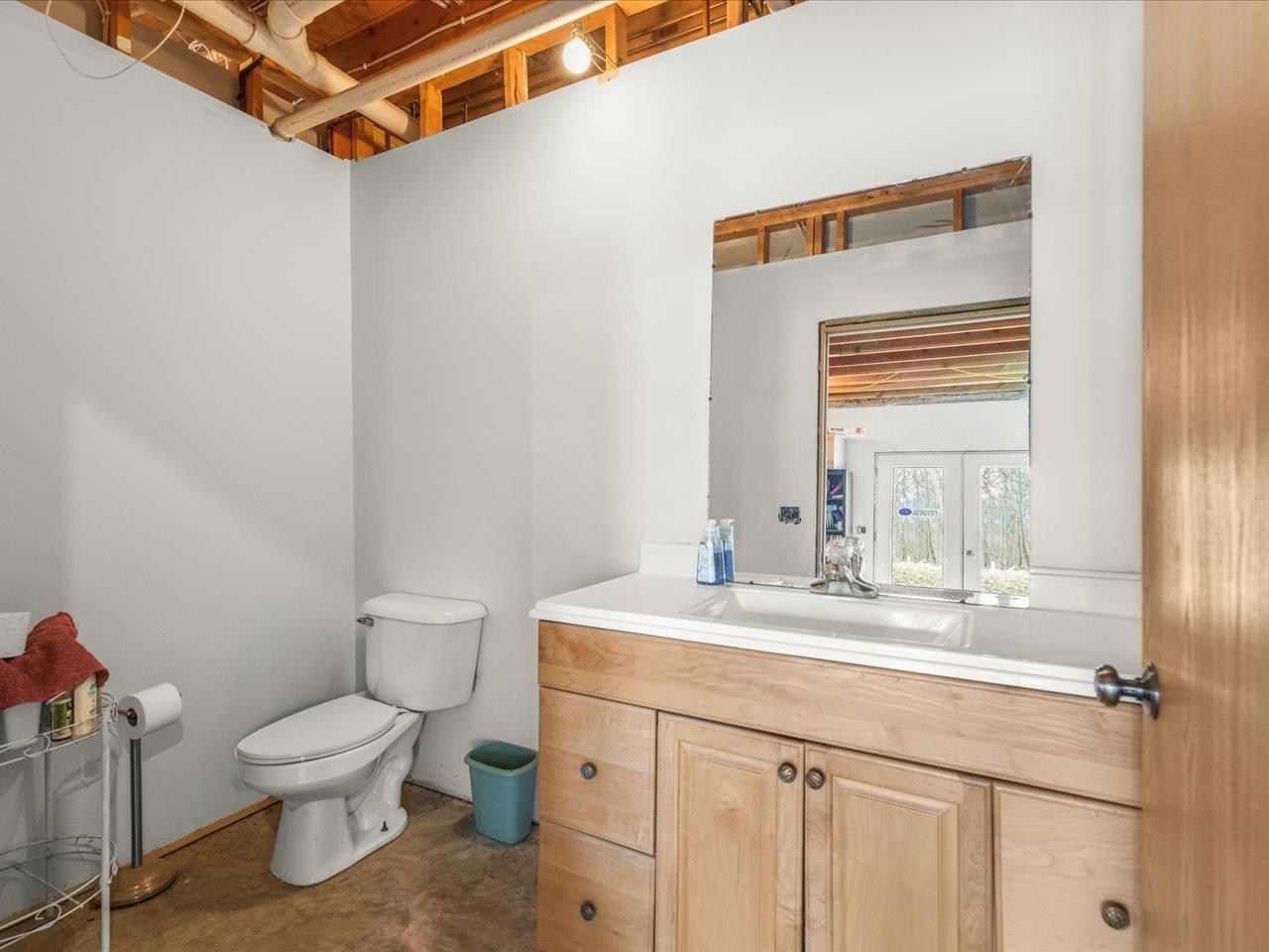11660 Farm School Road Durand, IL 61024 - Photo 28 of 47 a bathroom with a toilet sink and mirror