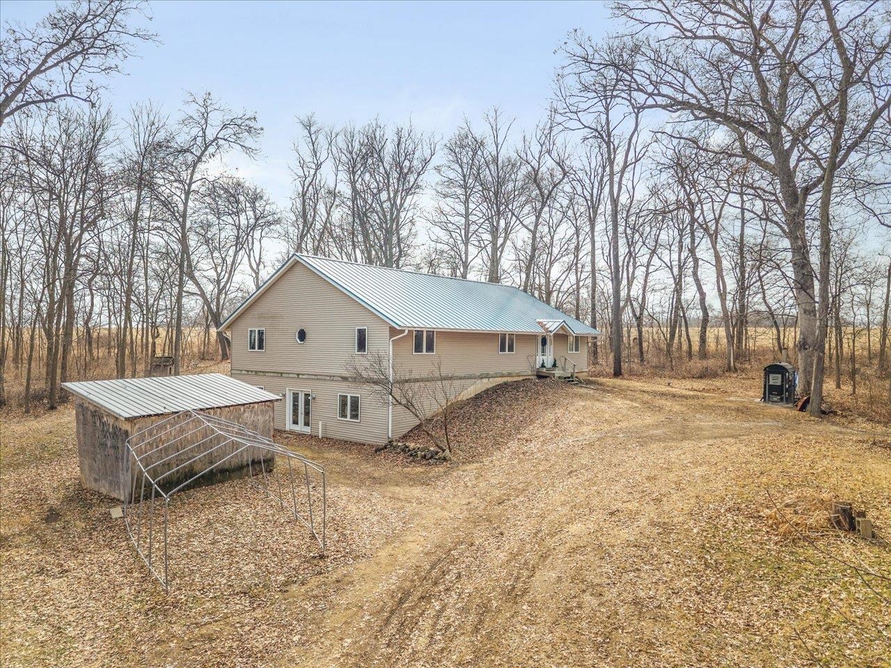 11660 Farm School Road Durand, IL 61024 - Photo 3 of 47 a view of a house with a yard covered in snow