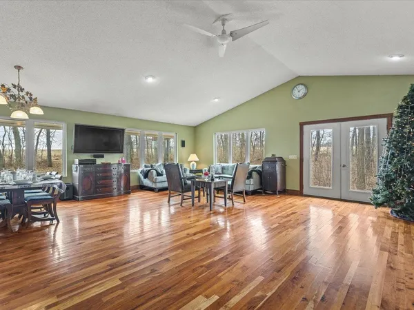 a living room with furniture and wooden floor