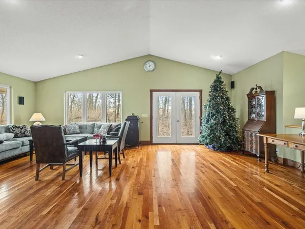 a view of a livingroom with furniture window and wooden floor