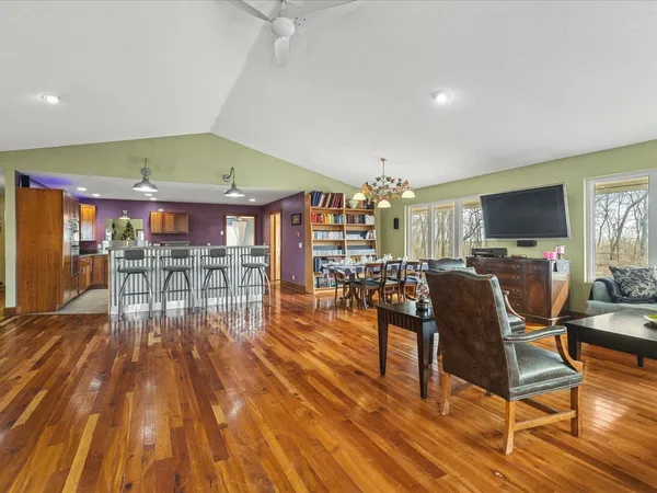 a dining room with furniture and wooden floor