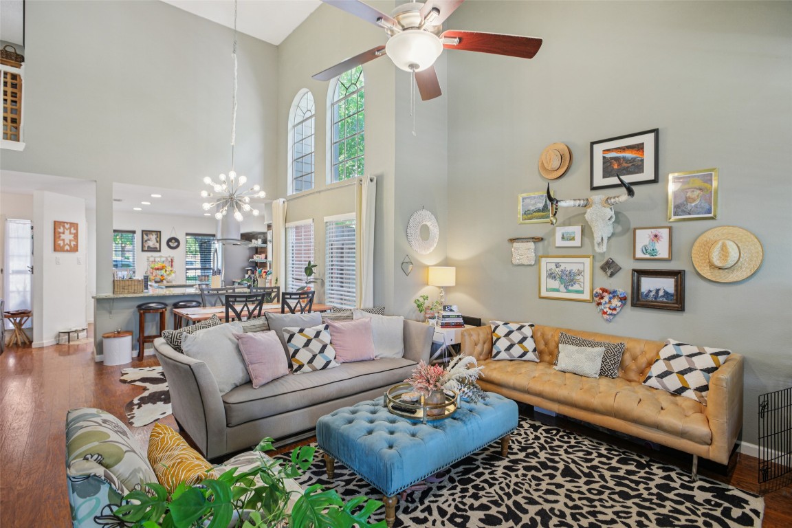a living room with furniture and a chandelier
