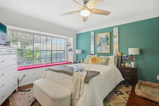 a bed room with a bed and a large window