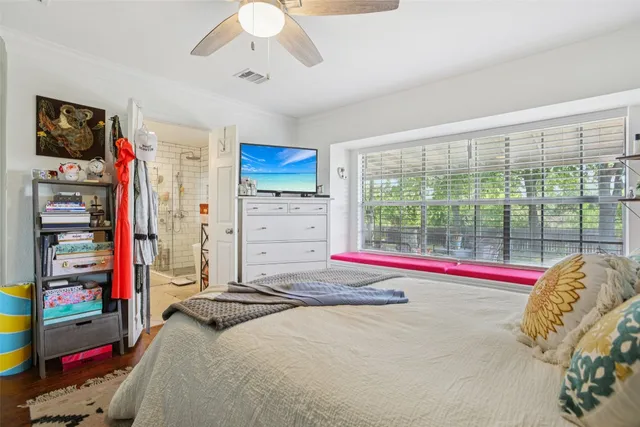 a bed room with a bed and a large window