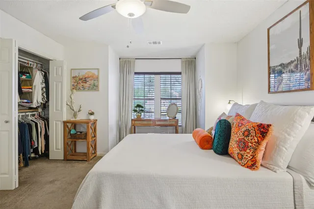 a bedroom with a large bed and a window