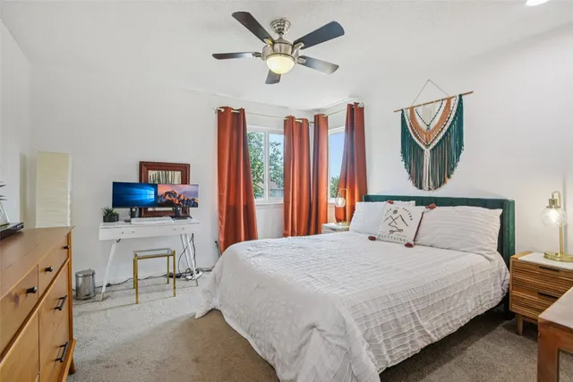 a bedroom with a balcony a bed and a flat screen tv