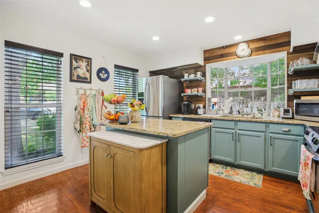 a kitchen with sink cabinets and wooden floor