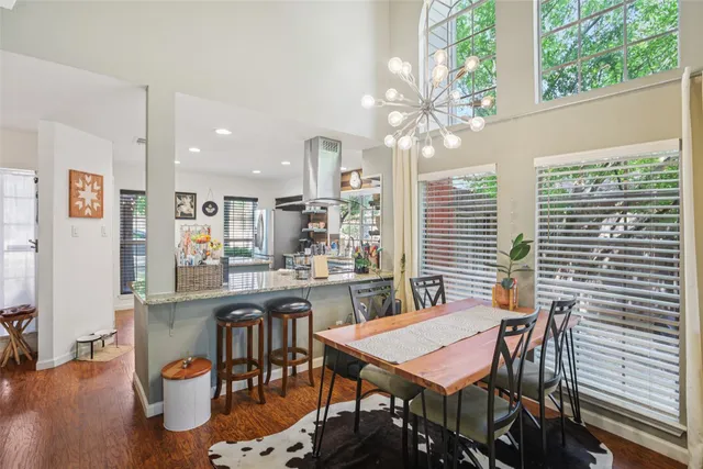 a view of a dining room with furniture and wooden floor