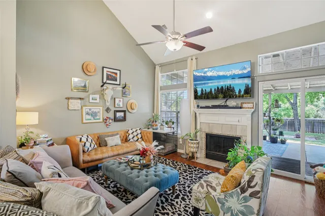 a living room with furniture fireplace and a large window