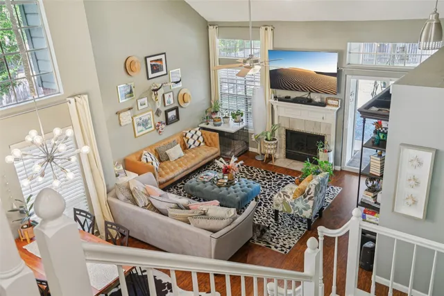 a living room with furniture a fireplace and a window