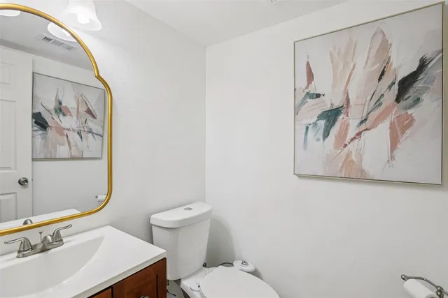 a white toilet sitting next to a bathroom sink