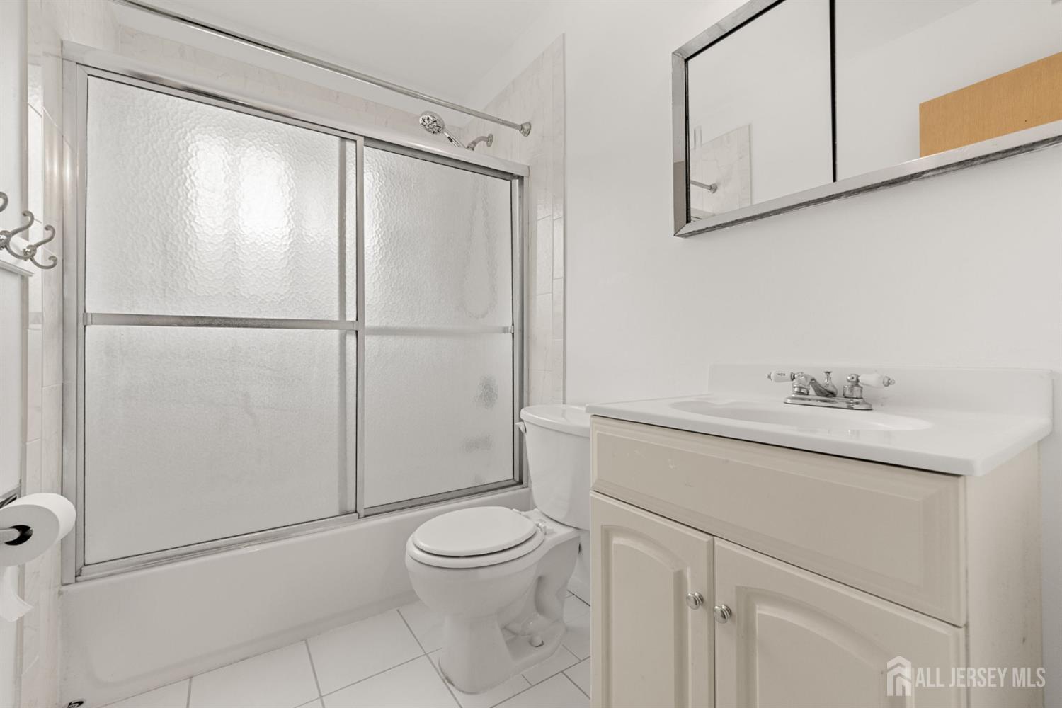 89 Van Buren Avenue, Unit 2 Metuchen, NJ 08840 - Photo 11 of 16 a bathroom with a sink a toilet and vanity