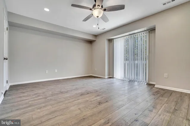 wooden floor in an empty room with a window