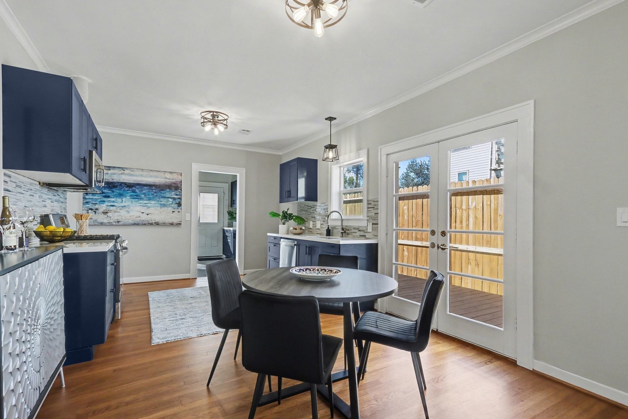 1901 Lexington Street Houston, TX 77098 - Photo 9 of 32 Discover a charming dining area and expansive kitchen through an elegant archway. The double glass doors opening to the side patio are ideal for outdoor grilling and relaxation.