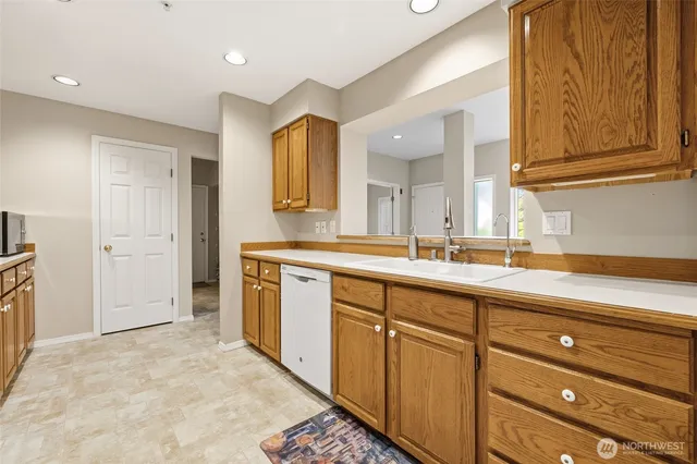 a spacious bathroom with a granite countertop sink and a mirror