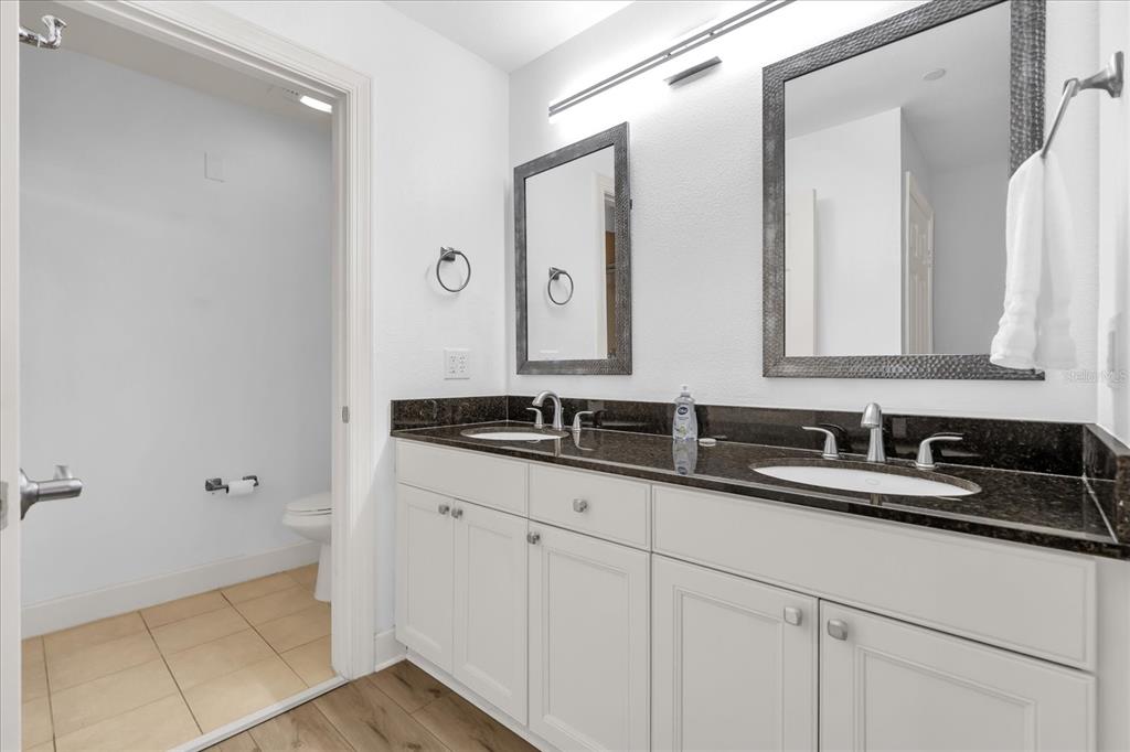1362 Centre Ct Ridge Drive, Unit 102 Reunion, FL 34747 - Photo 22 of 35 a bathroom with a sink and a mirror