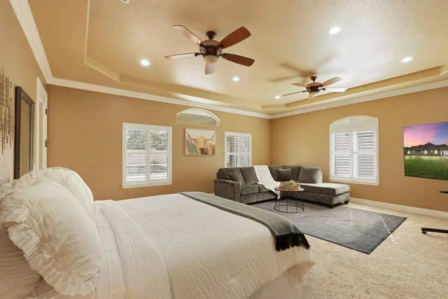 a living room with furniture and large windows