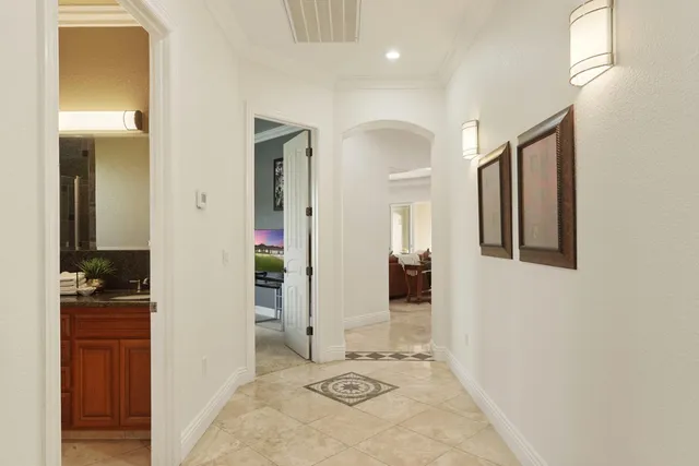 an aerial view of house with swimming pool and mountains in the background