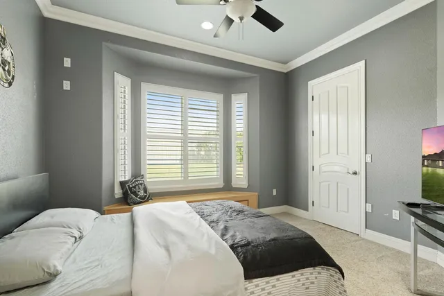 a backyard of a house with table and chairs and wooden fence
