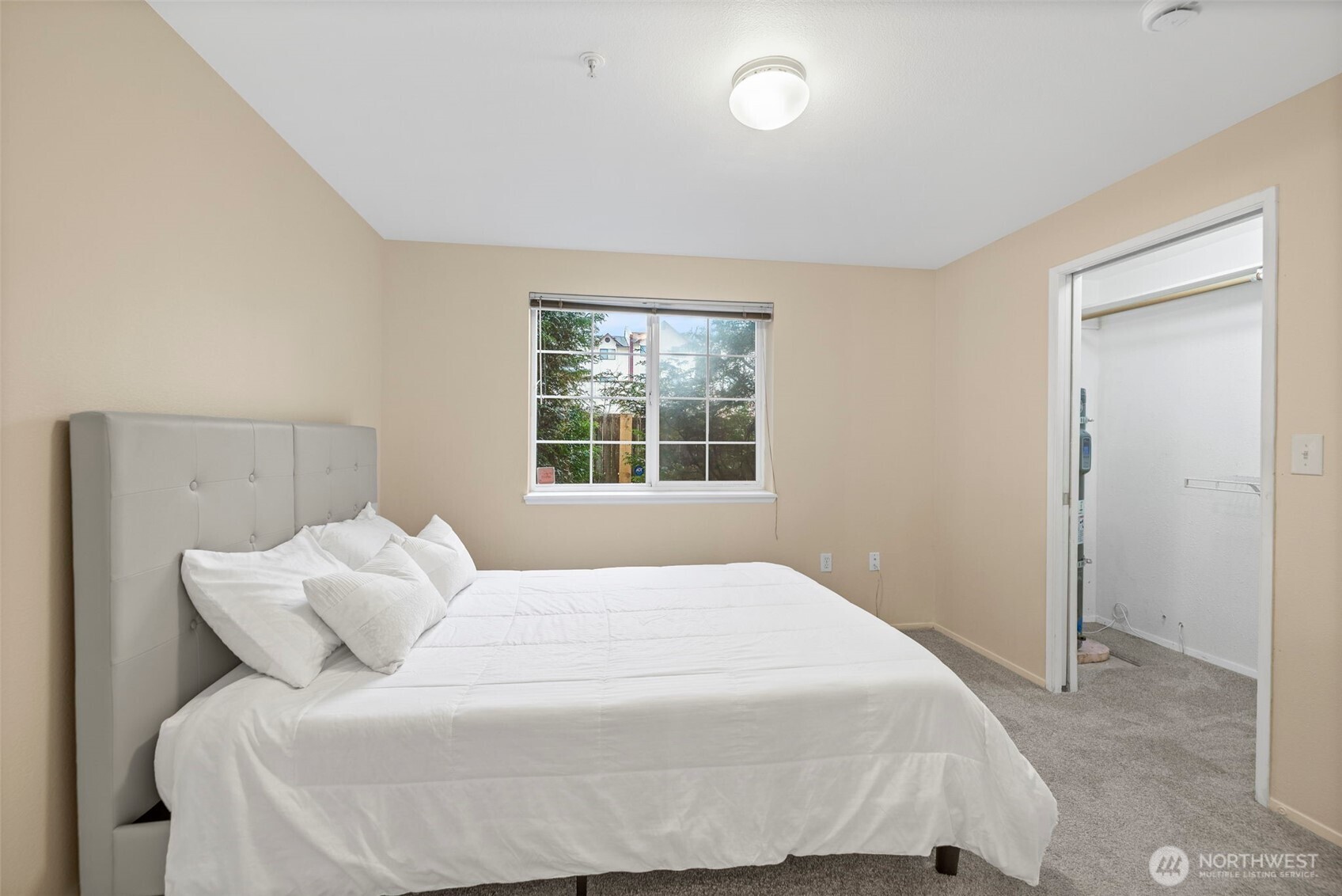 10824 Southeast 170th Street, Unit B103 Renton, WA 98055 - Photo 18 of 31 a bedroom with a bed and window