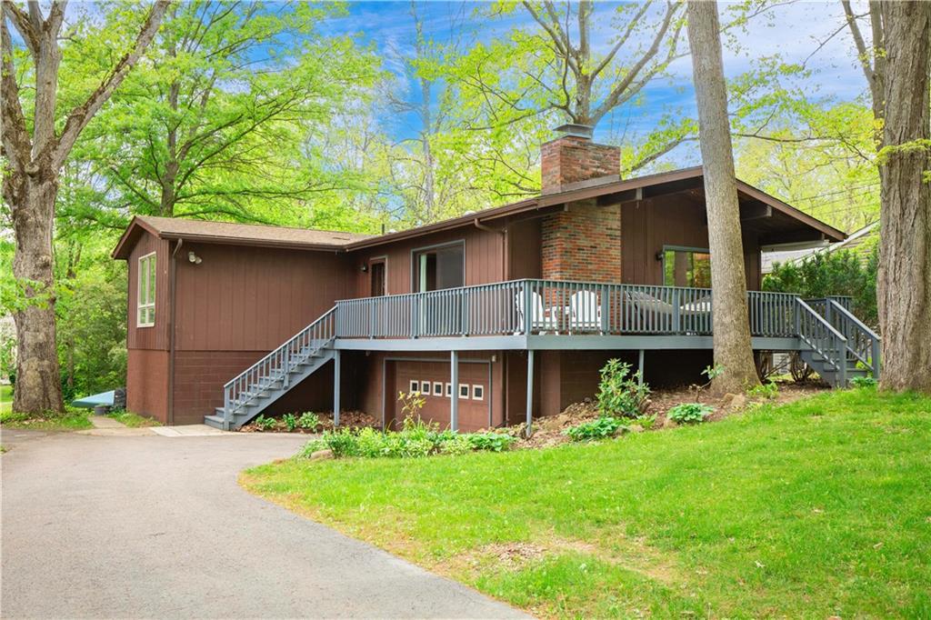 a front view of house with yard and green space