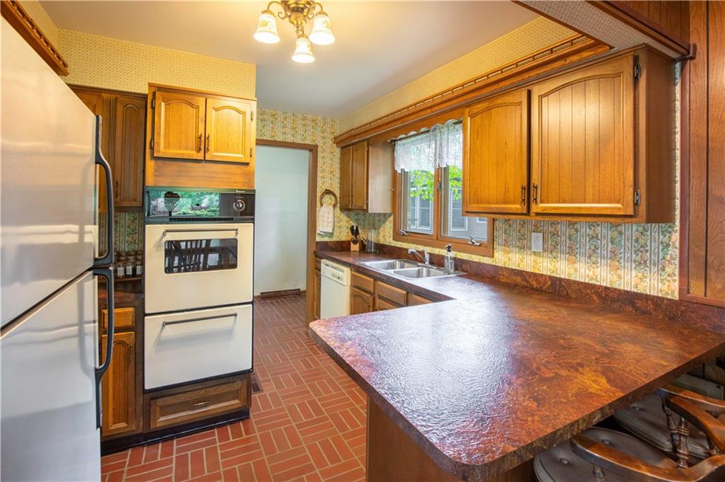 906 Aztec Trail Mercer, PA 16137 - Photo 9 of 27 a kitchen with stainless steel appliances granite countertop a refrigerator a stove and a sink with granite countertops