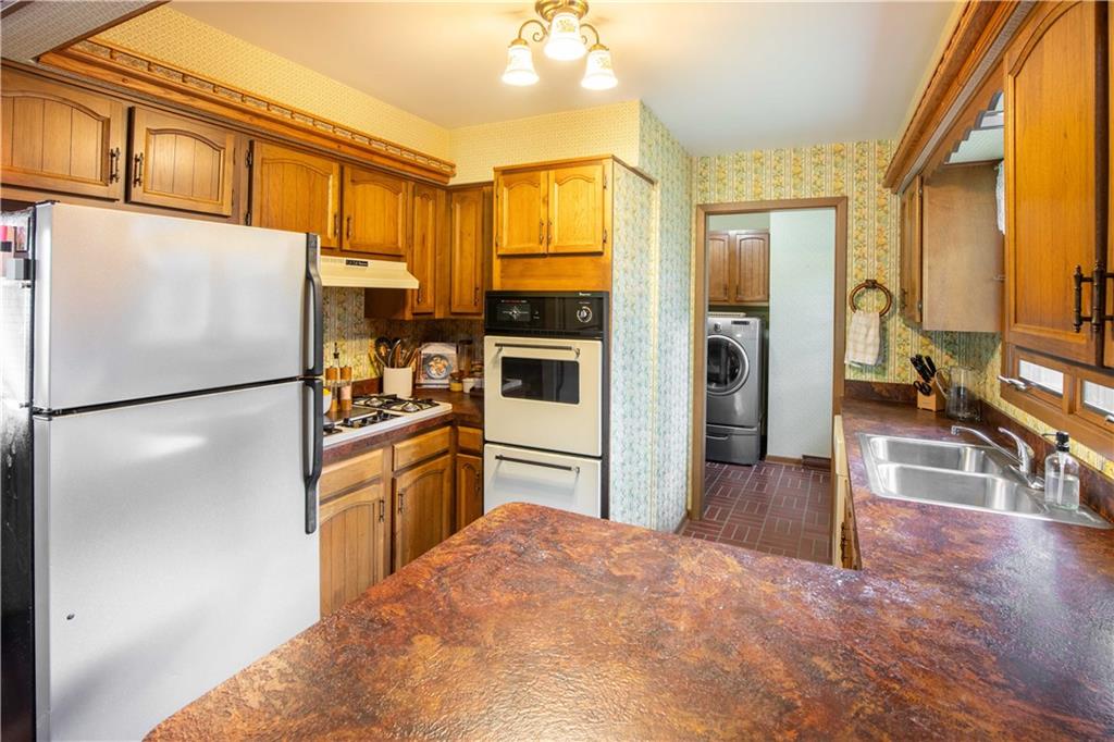906 Aztec Trail Mercer, PA 16137 - Photo 10 of 27 a kitchen with stainless steel appliances granite countertop a refrigerator and a sink