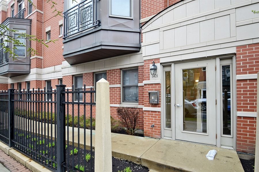 1421 South Halsted Street, Unit 1A Chicago, IL 60607 - Photo 2 of 15 a view of a brick building with many windows