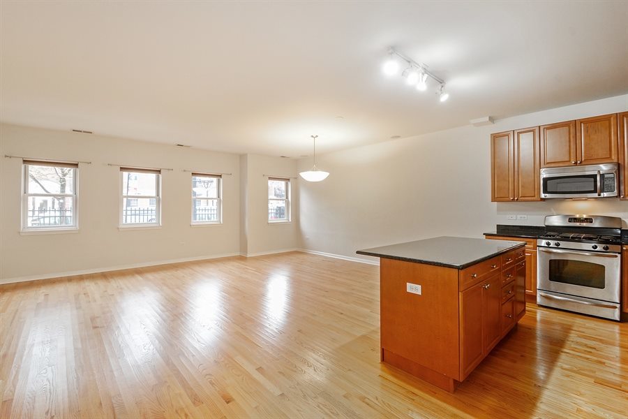 1421 South Halsted Street, Unit 1A Chicago, IL 60607 - Photo 5 of 15 a kitchen with stainless steel appliances granite countertop a stove top oven and sink