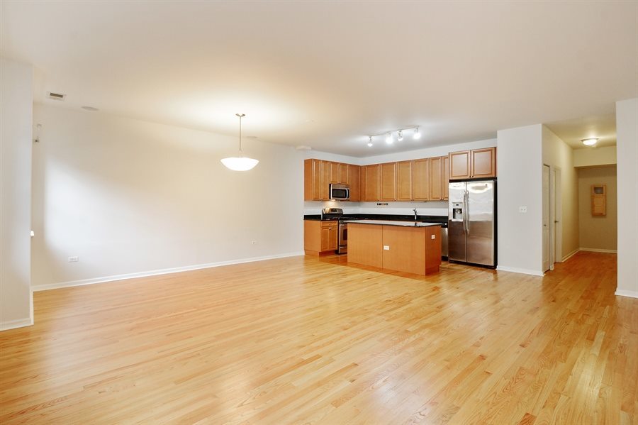 1421 South Halsted Street, Unit 1A Chicago, IL 60607 - Photo 7 of 15 a view of a kitchen with a sink and a refrigerator