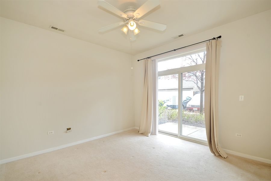 1421 South Halsted Street, Unit 1A Chicago, IL 60607 - Photo 8 of 15 an empty room with windows and ceiling fan