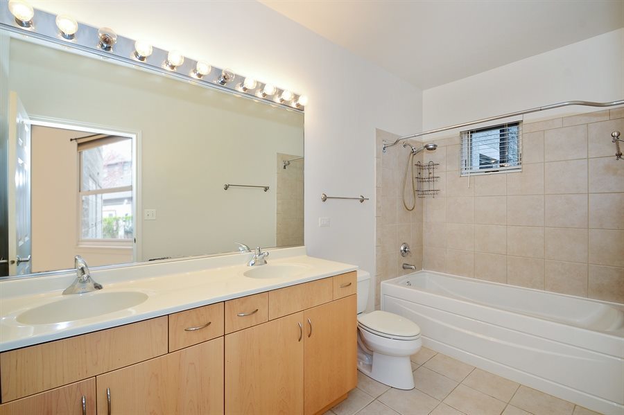 1421 South Halsted Street, Unit 1A Chicago, IL 60607 - Photo 10 of 15 a bathroom with a granite countertop sink a toilet and shower