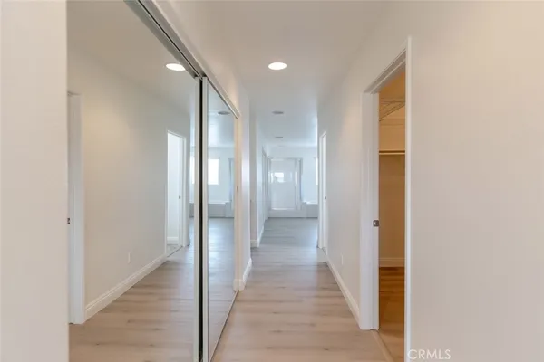 an empty room with a bathroom and mirror