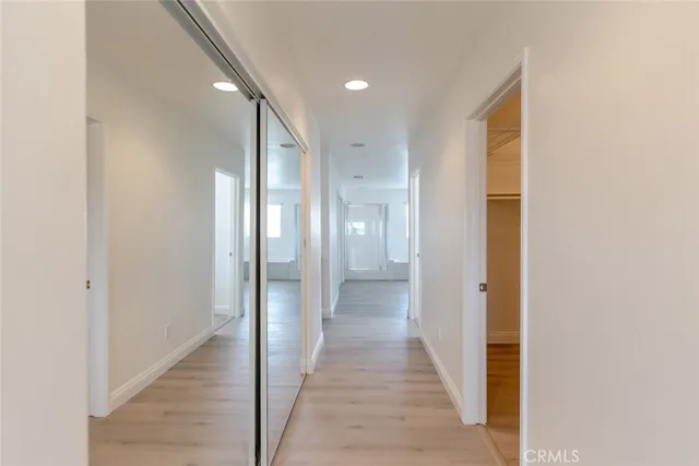 an empty room with a bathroom and mirror