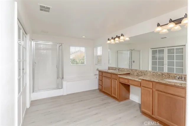 a bathroom with a granite countertop sink a toilet and shower
