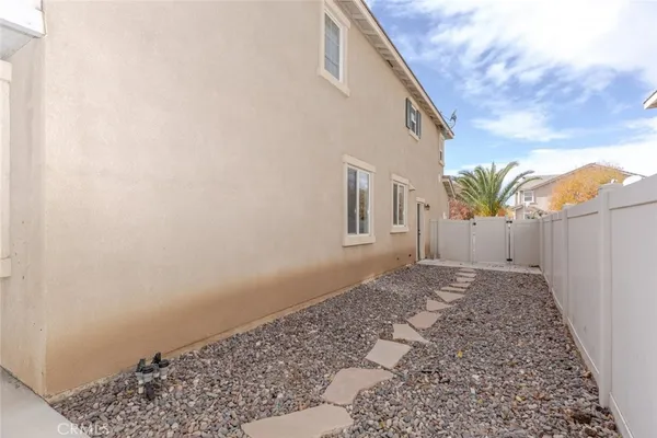 a view of a house with backyard and sitting area