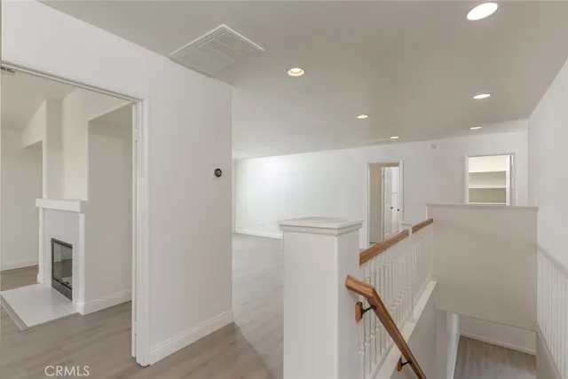 a view of hallway with furniture and a refrigerator